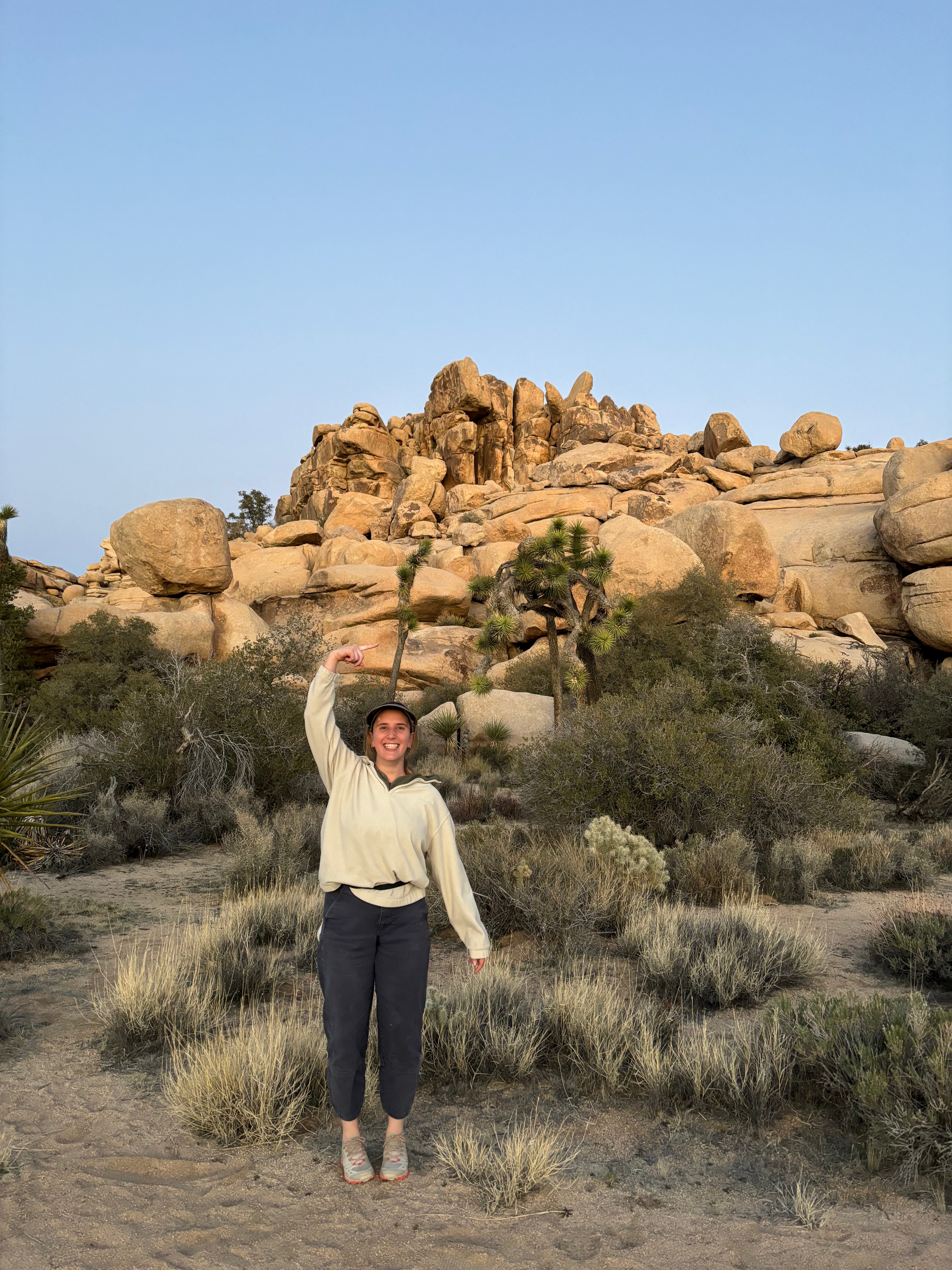 Girl pointing at a large hill in Joshua Tree