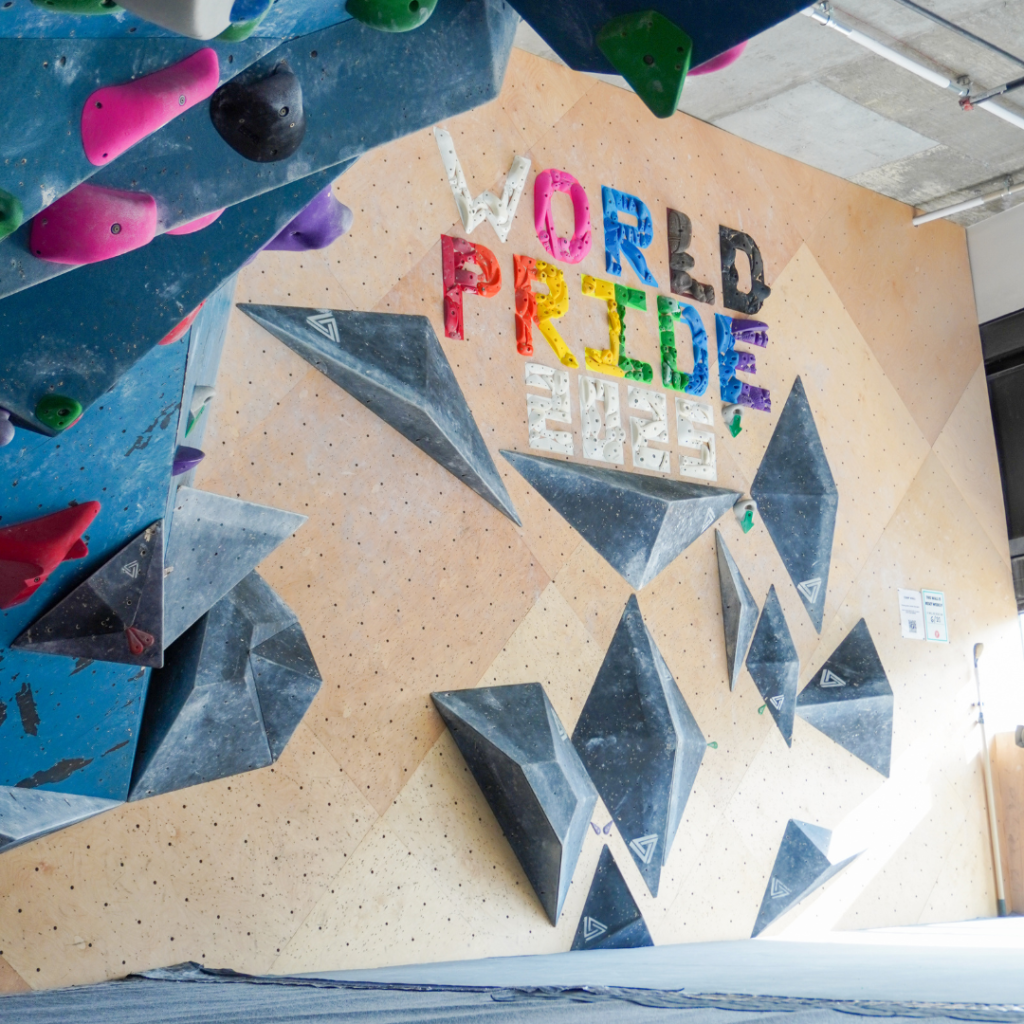 World Pride 2025 spelled out in rock climing holds at Bouldering Project